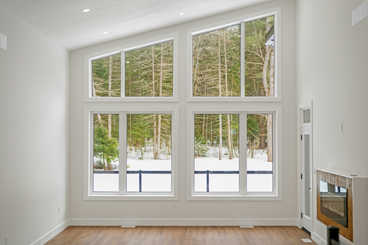 asymmetrical window framing a snowy winter landscape